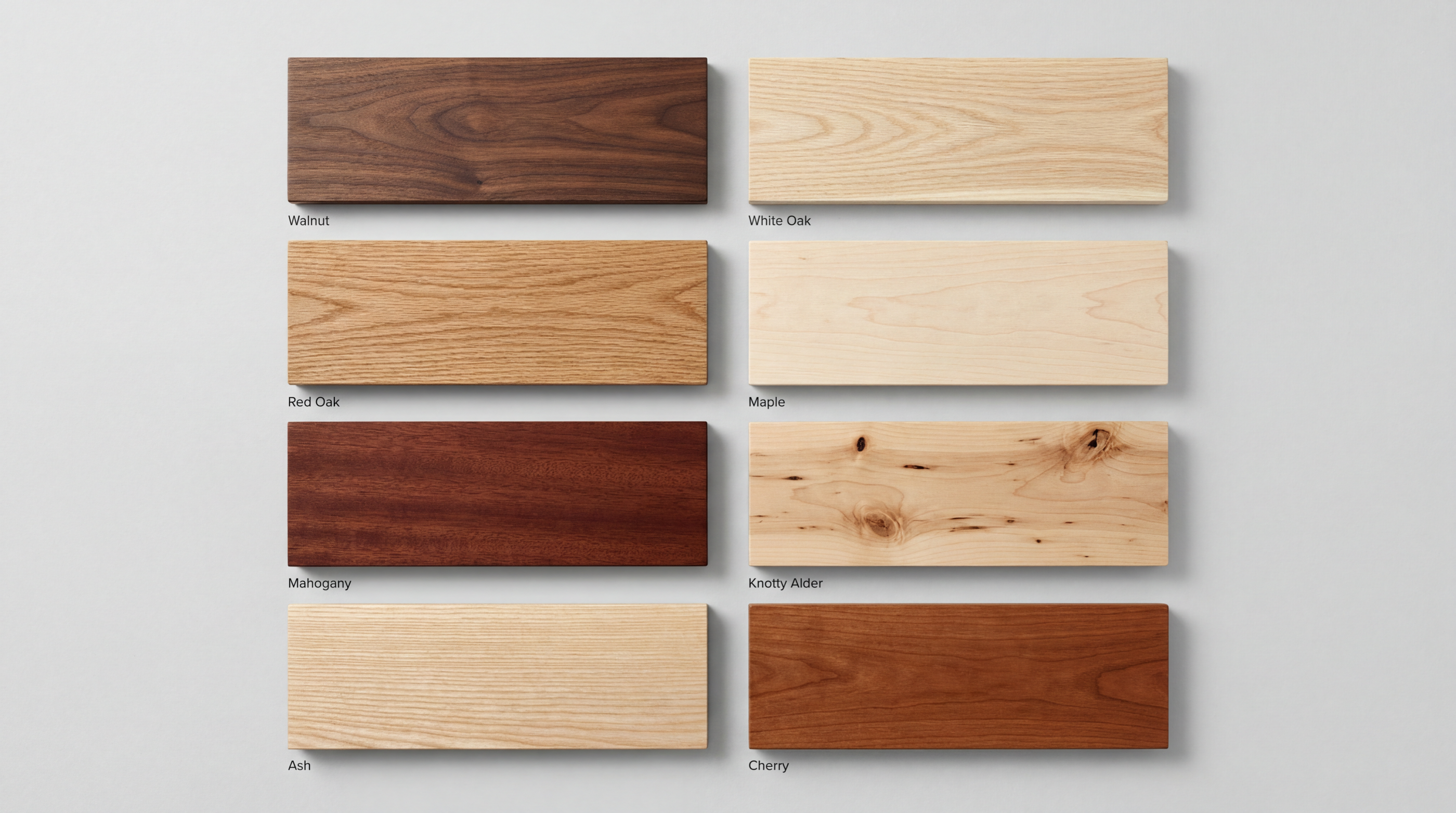 Selection of hardwood countertop samples including walnut, white oak, maple, cherry, and mahogany laid out on a work surface.