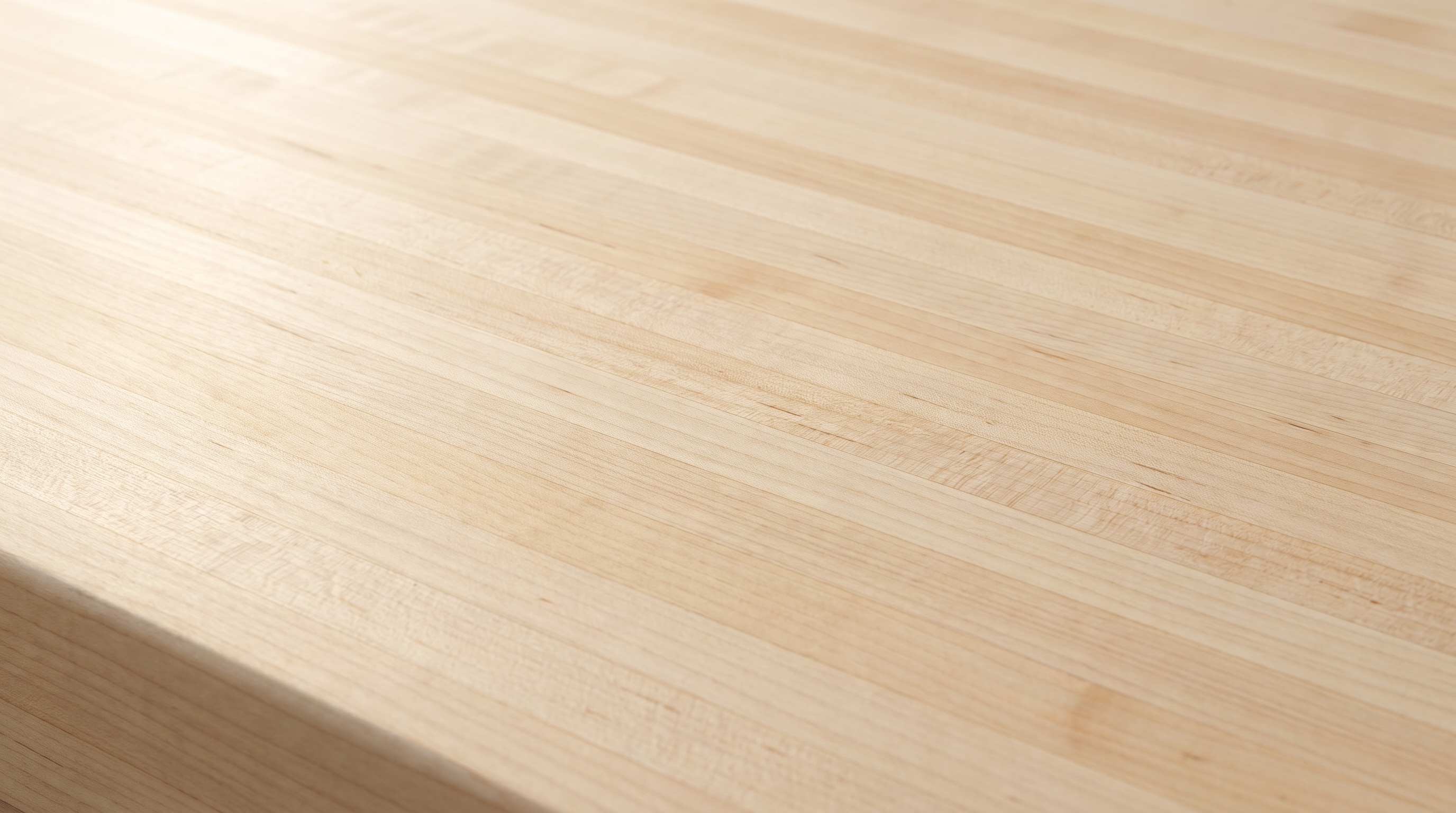 Natural hard maple edge grain butcher block countertop close-up, pale laminated strips under a clear hardwax oil